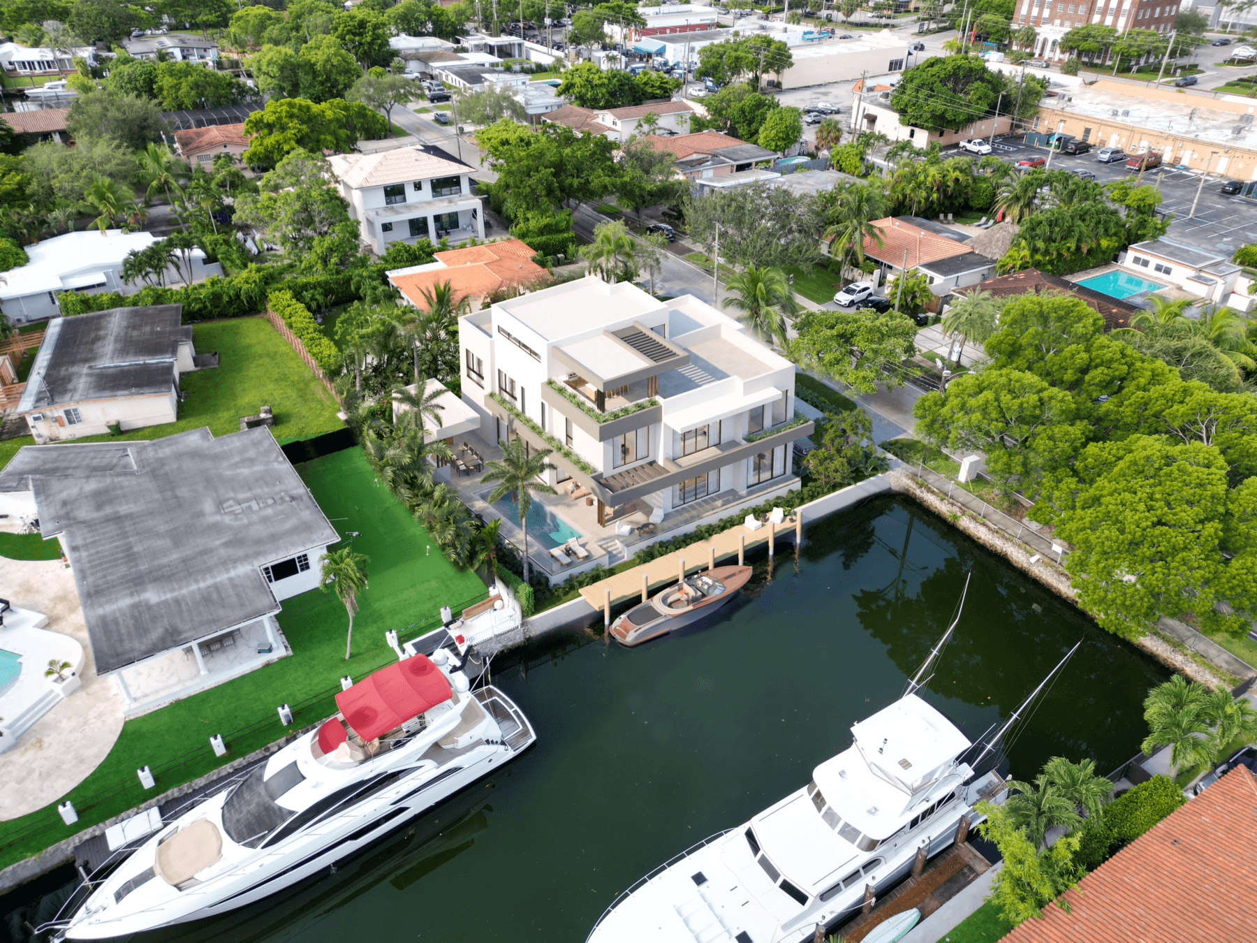 A modern style home that is on a waterfront lot with it's own dock. Yachts are docked at adjacent homes illustrating the value and potential cap rates on such a property.