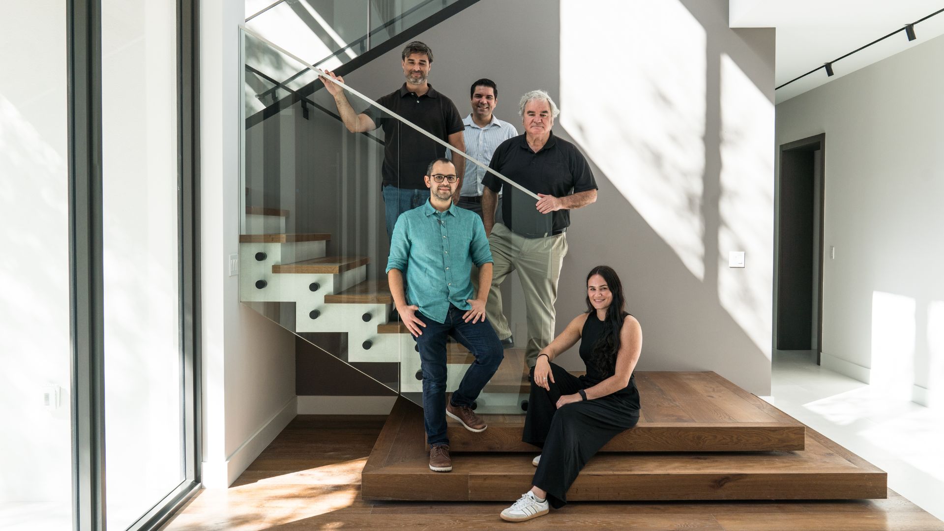 an image of the AGD Development team on the stairs in one of their luxury progects. They look happy and confident and professional and convey the very idea of being able to find real estate investment properties in Miami